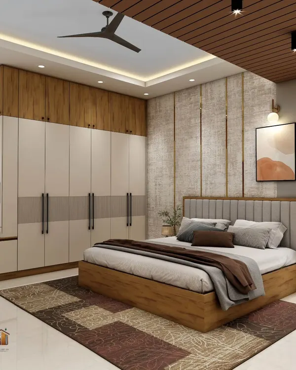A modern master bedroom featuring a floor-to-ceiling wardrobe with a built-in window seat. The combination of wood and neutral tones, along with a textured accent wall behind the bed, creates a warm and sophisticated retreat.