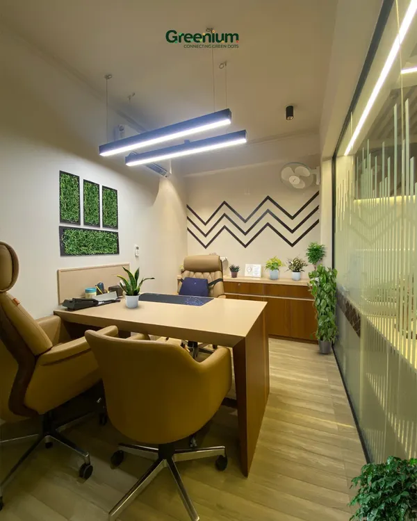 We transformed this office space into a modern green oasis. The addition of framed green wall panels and potted plants enhances the professional environment, boosts well-being, and adds a touch of style.