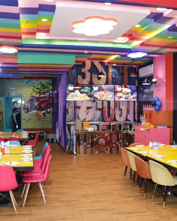 A look at our colorful and spacious dining area. The rainbow ceiling and vibrant decor create a cheerful atmosphere for any celebration.