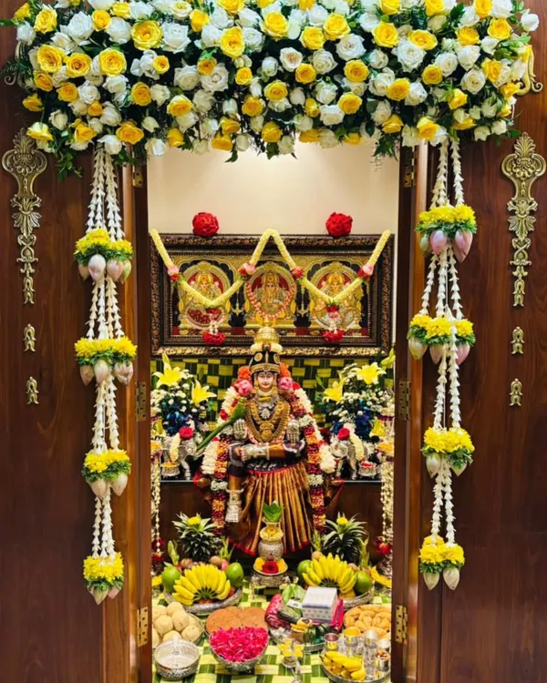 You will learn the art of decorating sacred spaces, like this beautiful pooja room for Varamahalakshmi. We cover everything from floral arrangements and fruit displays to traditional lotus and thomale garlands.