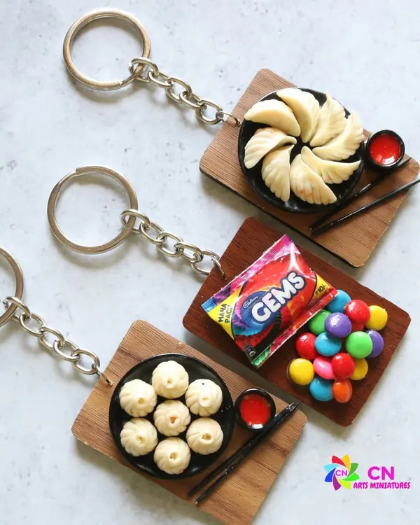 A collection of my food-themed keychains, featuring momos and Gems chocolate.