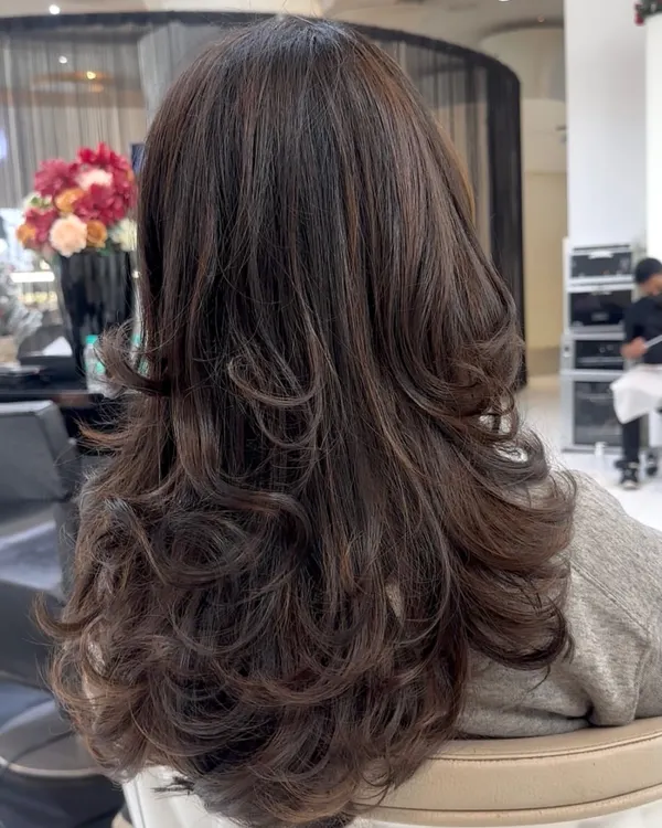 A perfect example of a Coffee Brunette transformation. The deep, rich tones have a beautiful shine, and the layered cut gives the hair wonderful movement and body.