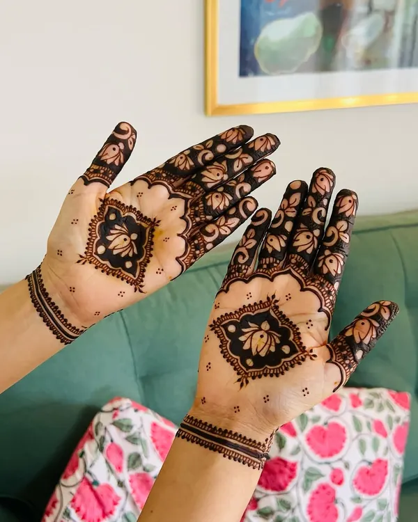 A bold design using negative space to make the central floral motif pop. This is a modern take on guest mehendi that is both minimal and intricate.