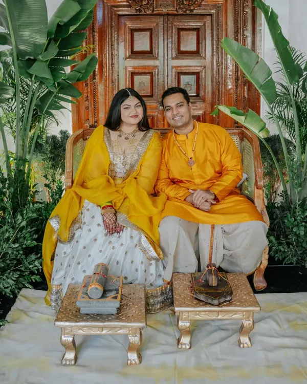 For Ridhi and Prashanth's Haldi, we embraced the venue's natural beauty. Using the vintage door as a backdrop and adding layers of greenery, we created a minimalistic and elegant theme that allowed the couple's "yellove" to shine.