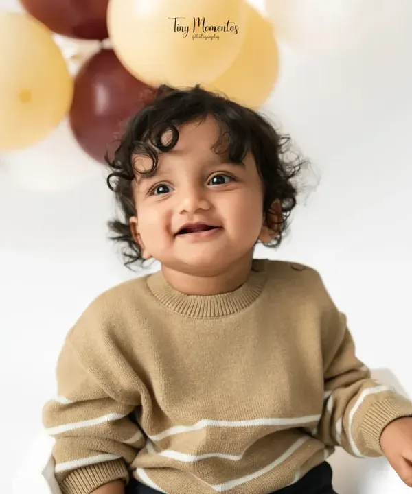 That heart-melting smile. This close-up portrait from a sitter session captures the pure joy and personality of this handsome little boy.