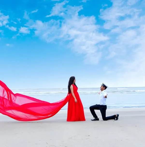(Hero Item) This is the moment love stories are made of. For this pre-wedding shoot in Goa, we created a truly cinematic scene on a serene beach. The flowing red gown against the vast sky and sea isn't just a picture; it's a feeling, a grand gesture of love immortalized. I help couples create these breathtaking, magazine-worthy moments that feel larger than life.
