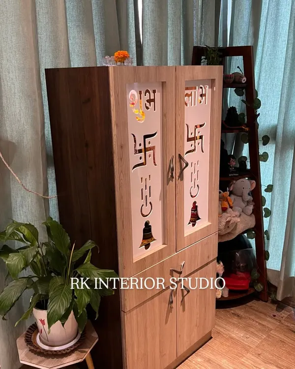 A standalone wooden mandir with beautiful jaali work on the doors, featuring sacred symbols. It's a perfect blend of tradition and modern craftsmanship.