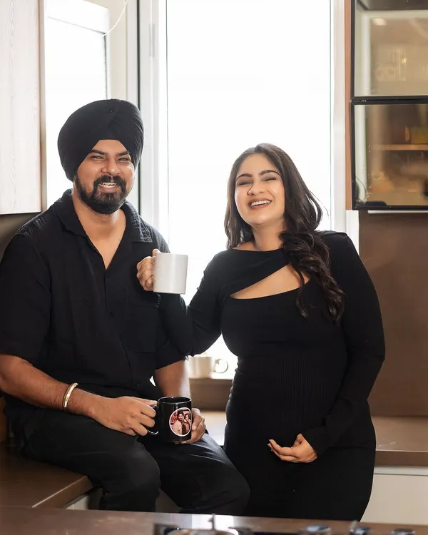 The simple joy of sharing a morning coffee. This candid shot in the kitchen captures a real, happy moment between the couple, showing that the most beautiful memories are often made in the most ordinary moments.