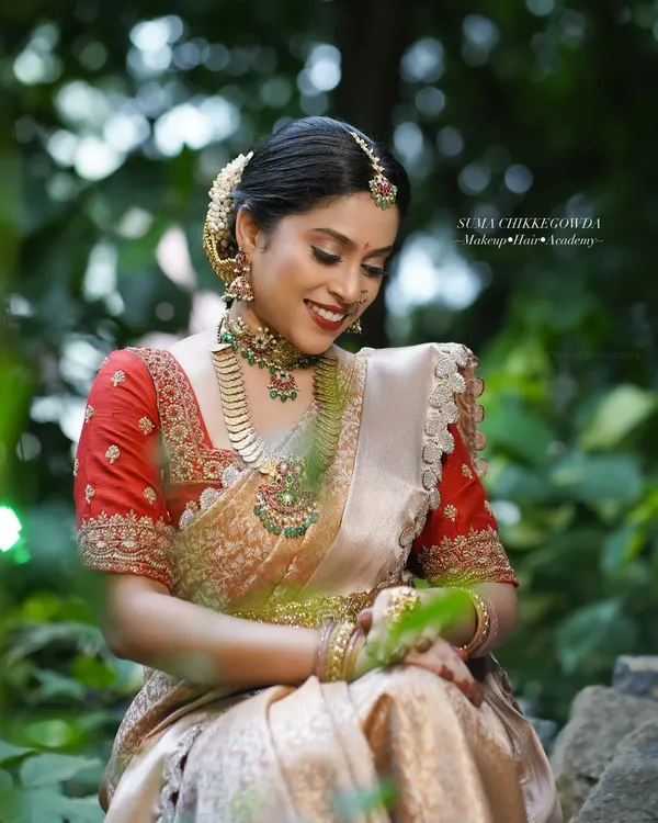 A candid moment from our demonstration shoot, showcasing the complete South Indian bridal look. The makeup remains flawless even in natural outdoor lighting, a testament to the techniques I teach for a long-lasting, radiant finish.