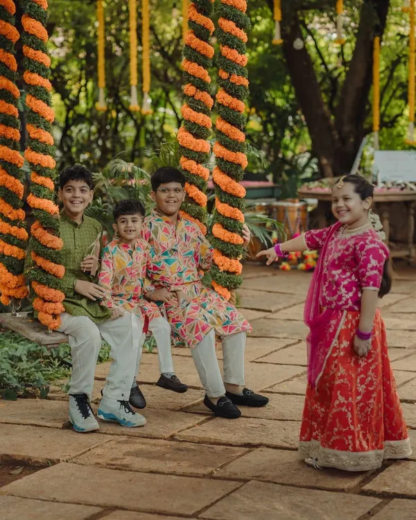 The children having a wonderful time on the floral oonjal. Capturing these moments of pure, simple joy among the younger guests is always a delight.