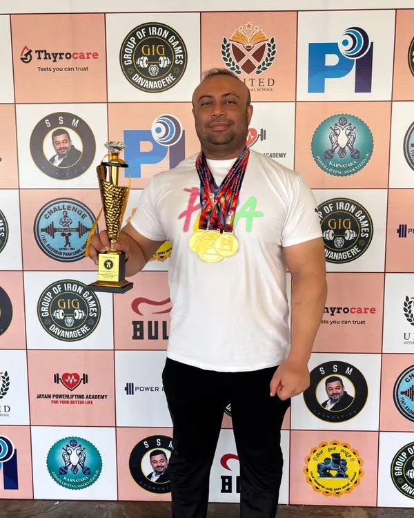 Holding the trophy and medals after winning the overall gold at the Senior National Equipped Powerlifting Championship in Karnataka.
