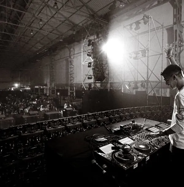 A wide, black and white shot from my performance opening for Talwiinder at Nesco. This shows the immense scale of the warehouse-style venue and the thousands of fans in attendance.