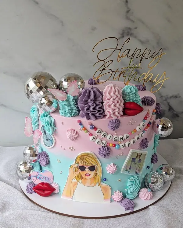 A cake for a true Swiftie. This design is inspired by Taylor Swift's eras, with disco balls, red lips, and other iconic imagery from her albums.