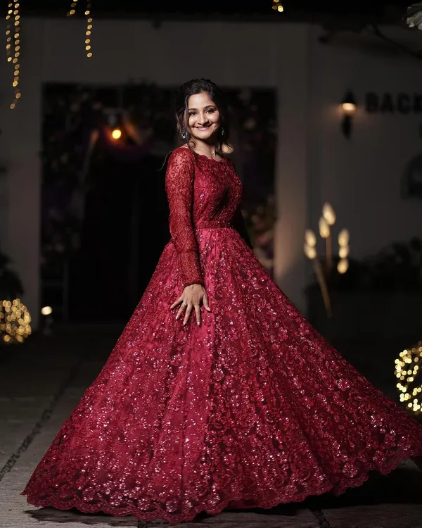 A full-length shot of this breathtaking red reception gown. The makeup was designed to be equally dramatic and elegant, creating a show-stopping look for her grand finale.