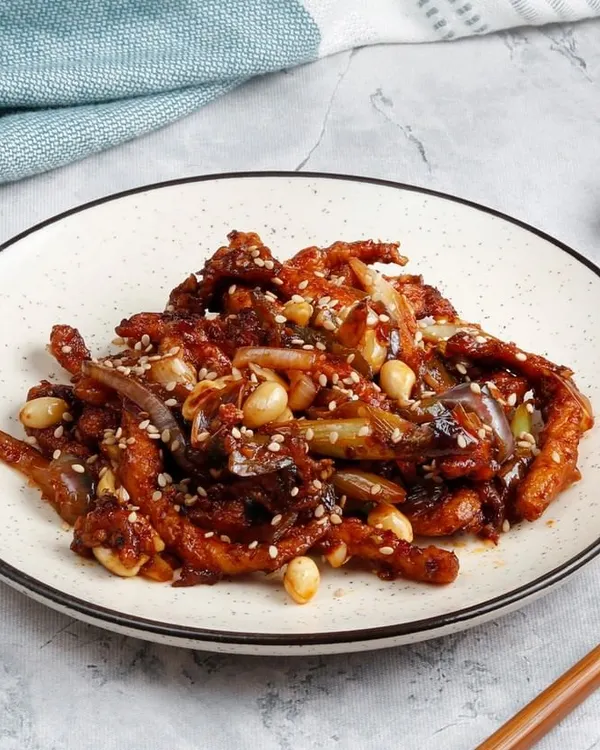 Our Honey Chicken with Peanuts. Crispy chicken pieces are tossed in a sweet honey-based sauce and finished with crunchy peanuts and sesame seeds.