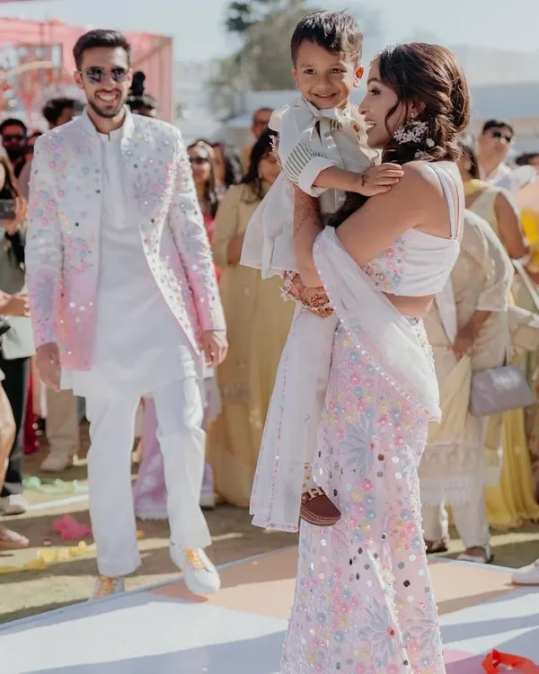 This is what it's all about: creating beautiful memories. I had the pleasure of designing this coordinated pastel ensemble for a wonderful family's special day. The intricate floral and mirror work on the lehenga, sharara, and the men's jacket created a unified, modern look for their celebration.