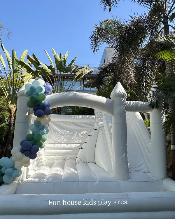 Our All-White Dream Castle is the perfect centerpiece for any stylish outdoor party. This 15x15 foot inflatable includes areas for jumping, sliding, and climbing, and can be decorated with balloons to match your event's color scheme perfectly.