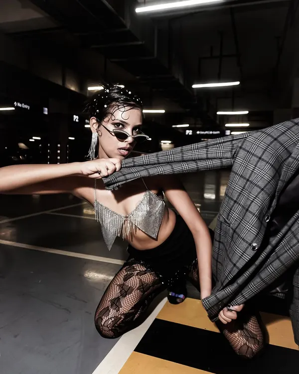 This is what I mean by grabbing the vibes that make you stop and stare. A high-energy, editorial fashion shot in an unconventional location, using dynamic posing and dramatic lighting to create a powerful, scroll-stopping image.