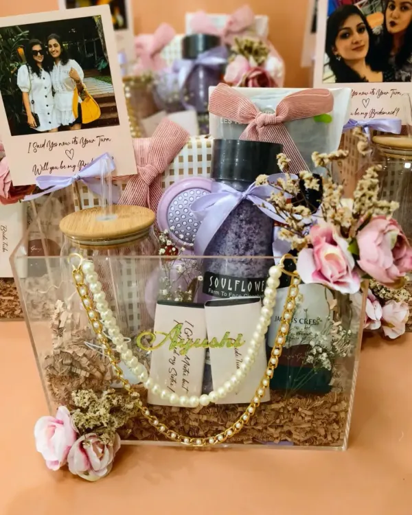 Another view of the personalized acrylic bridesmaid hampers. Each one includes a jade roller, custom coffee tumbler, bath salts, and wine, all tailored to tell a story.