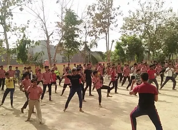 A large group of students during an outdoor self-defense workshop. We often conduct sessions in open spaces to teach skills applicable outside the dojo.