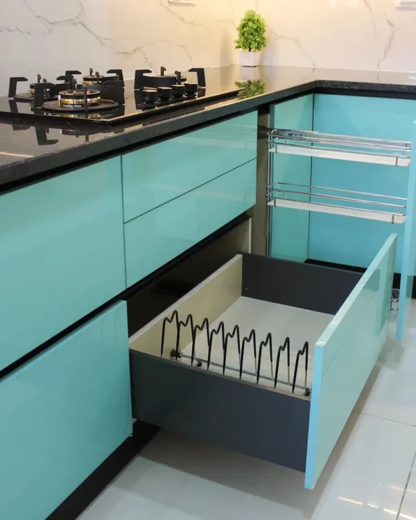 We believe in beauty that is also practical. This image showcases our smart storage solutions, including a multi-tiered pull-out spice rack and a deep drawer with a custom plate organizer, ensuring everything has its place.
