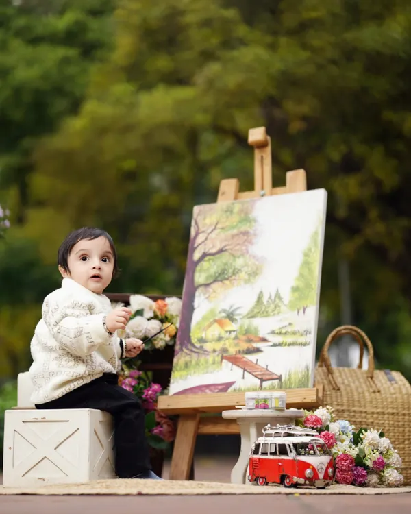 This is where the magic begins. An outdoor 'Little Artist' session, perfect for capturing the wonder and creativity of childhood against a beautiful, natural backdrop.