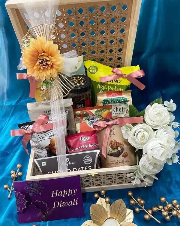 An open view of our cane and wood Diwali hamper, overflowing with high-protein snacks, choco dates, and brownies. It's a perfect blend of healthy and indulgent treats for the festive season.