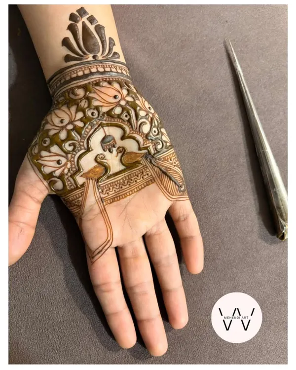 This Pichwai-inspired peacock design is one of my absolute favorites to create. I love how the fine lines and floral fillers come together to frame the two peacocks, with a lotus cuff at the wrist. This is the kind of detailed, story-telling art I can create for you.