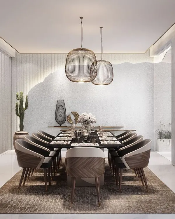 This dining room embodies minimalist luxury. The space is defined by a feature wall with an organic, broken-edge detail, complemented by contemporary furniture and abstract art, creating a serene and sophisticated dining experience.