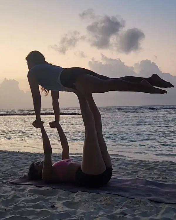 There's nothing like playing with acro yoga as the sun sets over the ocean. It's a practice built on trust, communication, and shared balance, and it always ends in smiles.