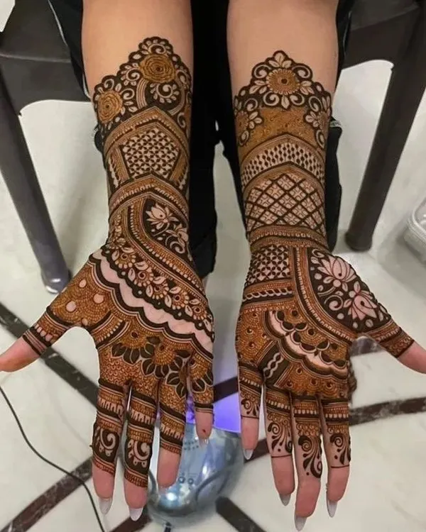 A beautiful example of a symmetrical design for both hands. This style uses a mix of paisleys, florals, and geometric grids to create a balanced and full look.