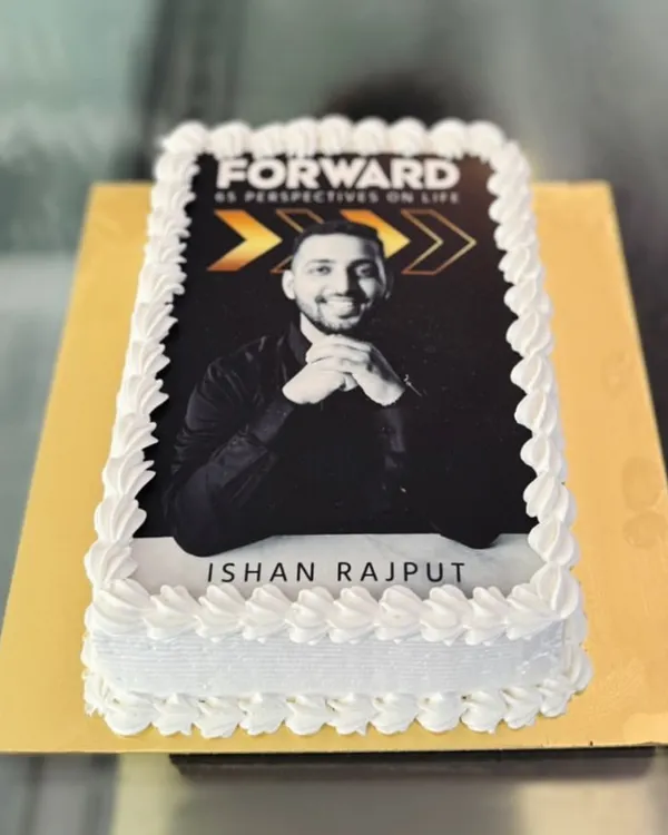 A rectangular photo cake created for a book launch or corporate event, featuring a high-quality edible print of the author.