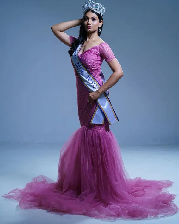 A pageant winner looking regal in my pink off-shoulder mermaid gown. The fitted silhouette and flared tulle bottom create a stunning, award-winning look.