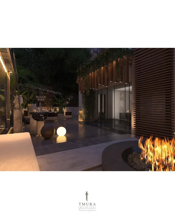 We designed this terrace as a true outdoor living room, complete with a central fire pit for warmth and ambiance. The space is framed by lush greenery and wooden cladding, creating a private, resort-like escape.