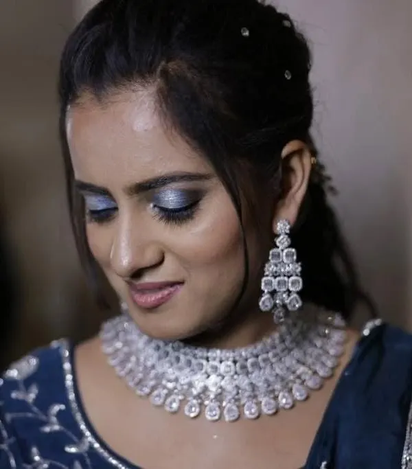A client looking absolutely glamorous for her sangeet night. She is wearing a dazzling rhodium-polished American Diamond necklace that sparkles with every move.