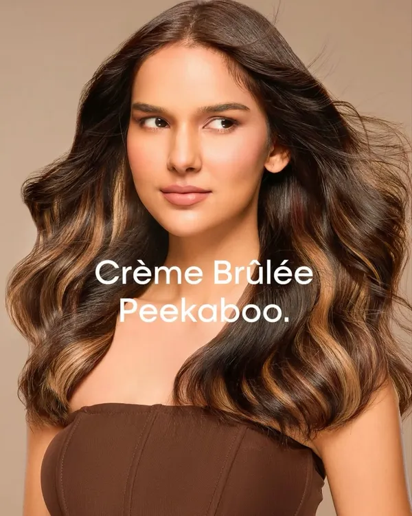 This is our Crème Brûlée Peekaboo look, a signature from the Bespoke Brunette Collection. We create dimension with a layered twist, using hidden panels of lighter color that offer a beautiful surprise with every movement.