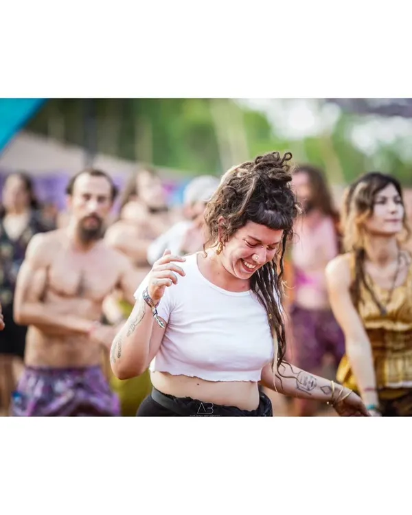 The pure, uninhibited joy of dancing. This candid shot from a music festival captures a moment of complete freedom and happiness.