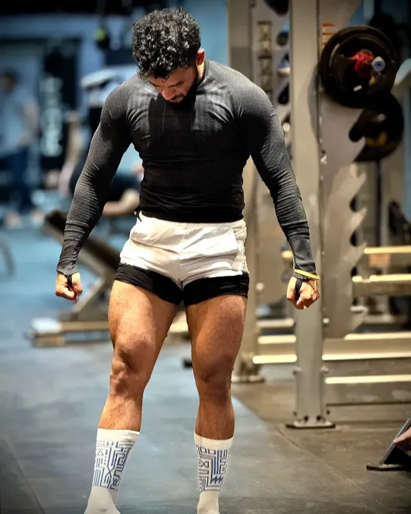 Strong legs are the pillars of a strong body. This pose shows the result of consistent, heavy leg days, building both size and definition in the quads.