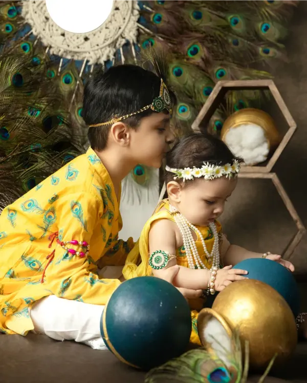 A touching moment between two brothers dressed for Janmashtami, as the older one places a protective kiss on his baby brother's head.