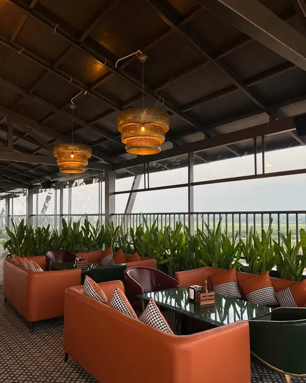 A comfortable lounge area at 'The Soda Factory' pub, where we used rows of tall, leafy plants to create natural partitions between seating zones. This adds a sense of intimacy and brings a soft, organic element to the decor.