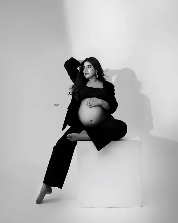 Mamma acing the game of light. This modern, high-fashion black and white portrait showcases a powerful pose and beautiful lighting.