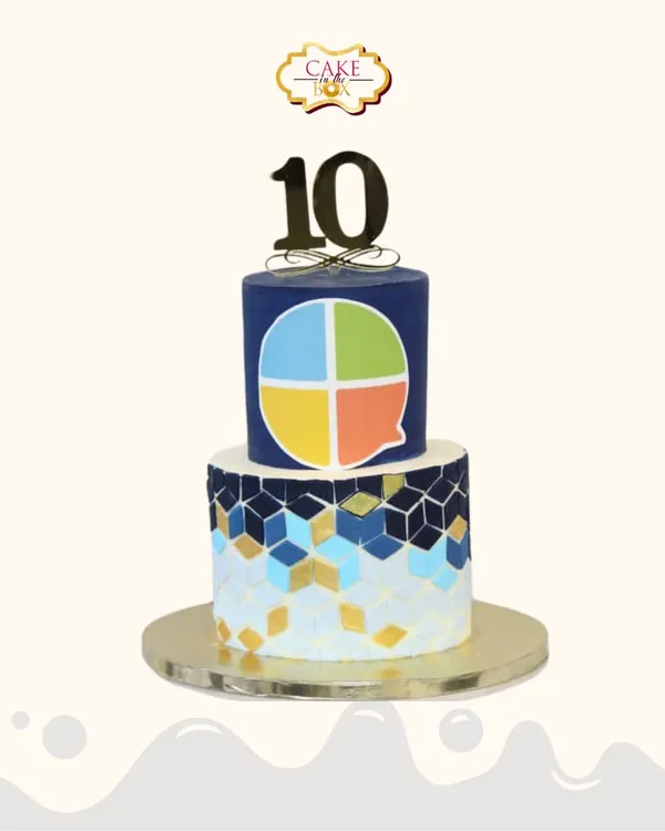 A sharp and modern cake celebrating a decade of success for Scroll Mantra. This two-tiered design features the company's logo and a geometric pattern in their brand colors.