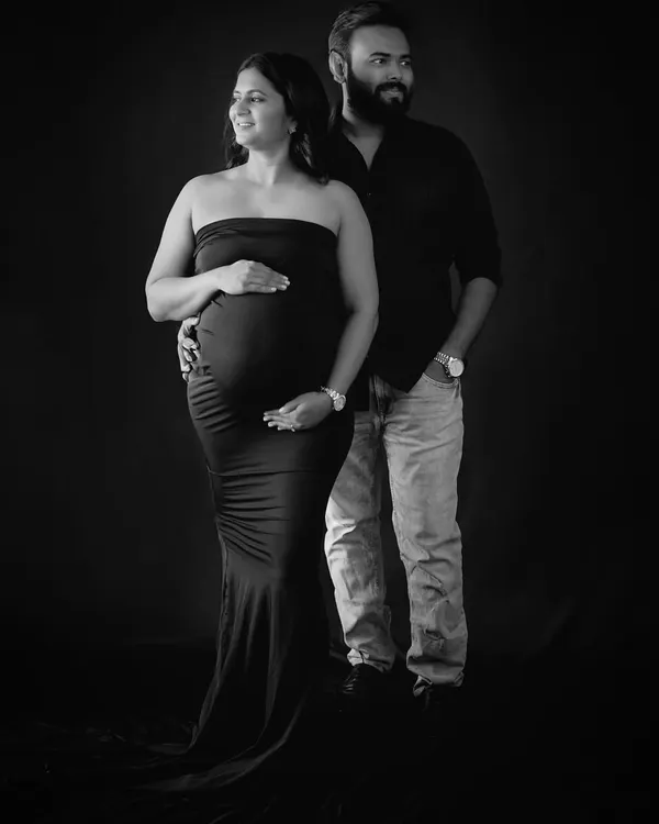 A classic black and white studio portrait of a couple. This style is elegant, powerful, and focuses entirely on their connection.