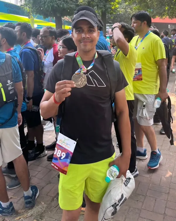The reward after the hard work. Holding my finisher's medal at the Vedanta Delhi Half Marathon. This is the feeling of accomplishment I want all my clients to experience.
