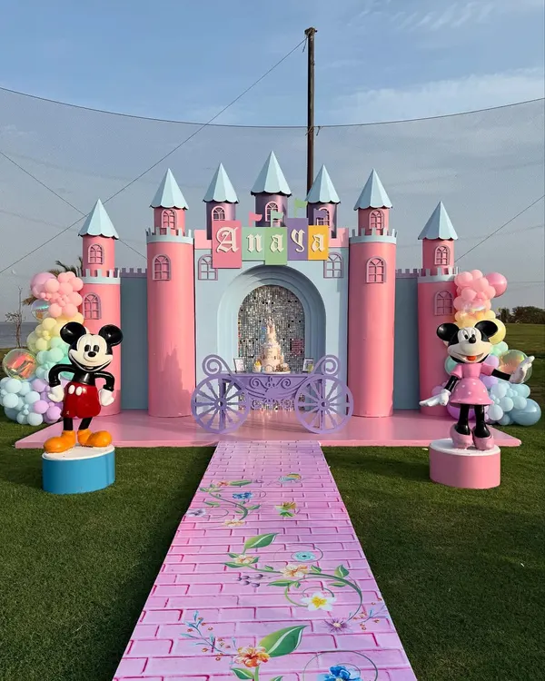 A fairytale castle fit for a princess, complete with Mickey and Minnie to welcome the guests. This large-scale outdoor setup shows our ability to create truly grand and magical entrances.