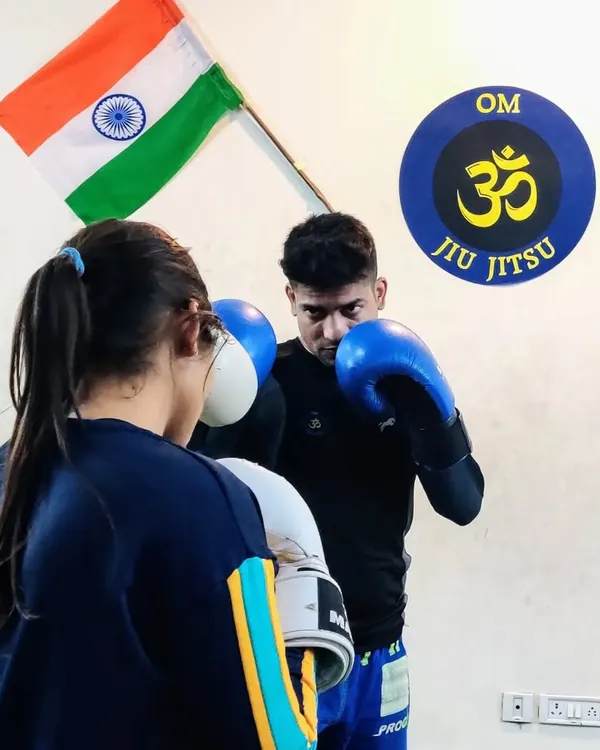 Focusing on the basics during a boxing drill. No matter how advanced you get, solid fundamentals are the key to effective striking. Here, I'm working with a student on her guard and punch delivery.