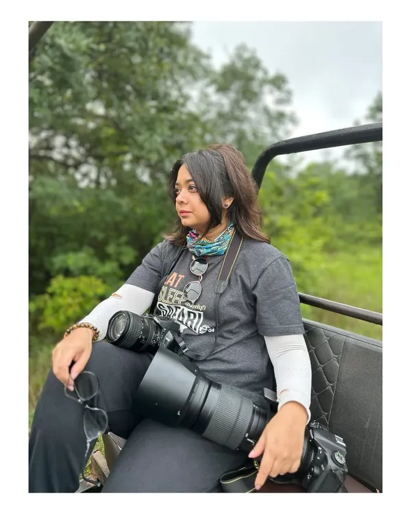 Me on safari, ready for action with my cameras. I call them my bazookas! This is my happy place, out in the wild, ready to capture a story.