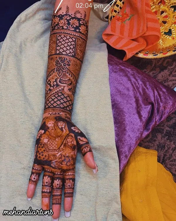A close up of a Kanyadaan ceremony portrait on the palm. This is a very emotional and special element to include in a bride's mehandi, celebrating the bond with her parents.