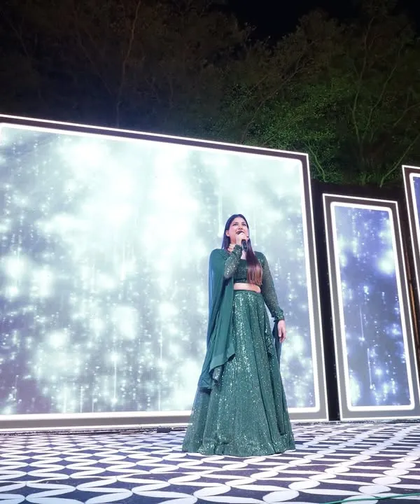 On stage at a beautiful outdoor Sangeet. The stunning LED backdrop set the mood, and I made sure my energy matched the vibrant setting to keep the celebration going all night.