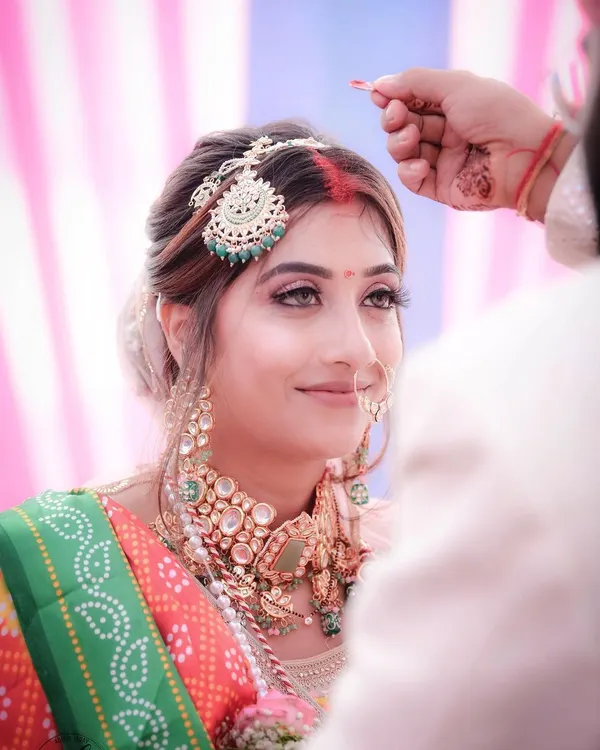 The sindoor ceremony is one of the most significant moments in a Hindu wedding. I focused on the bride's serene expression as the sindoor is applied, capturing the emotion and sanctity of this beautiful ritual.